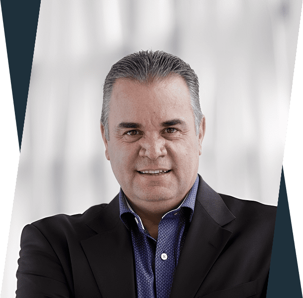 Portrait of a middle-aged man in a dark blazer and blue shirt.