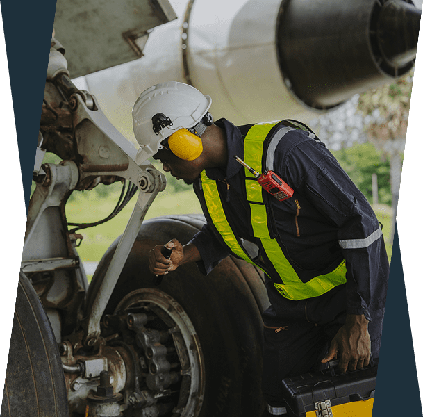 Aircraft mechanic inspecting landing gear components.