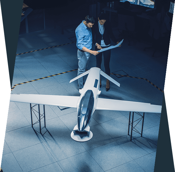 Two people discussing aircraft design blueprint.