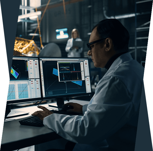 Scientist analyzing data on computer screens.